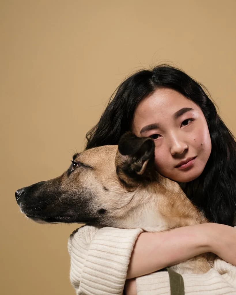 Dog owner hugging her dog